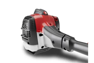 Close-up of a power tool engine with a vented cover and ergonomic handle.