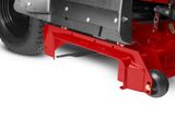 Close-up view of a mower's cutting deck and wheel assembly.
