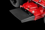 Close-up view of a commercial mower's cutting deck with protective flap.