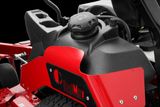 Close-up of a fuel tank on a lawn mower with visible fuel cap and handle.