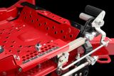 Close-up view of a mechanical component with levers and perforated metal parts.